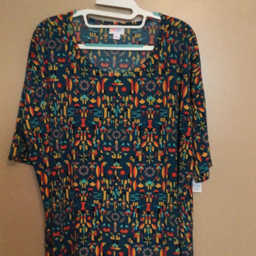 NWT Lularoe Irma Shirt, size Medium. Blue with geometric pattern in red, yellow
